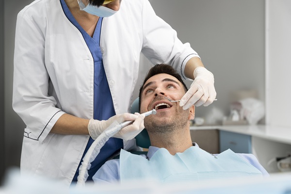 Dentist performing safe wisdom tooth removal procedure