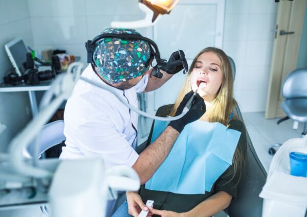 Dentist examining a patient during laser-assisted root canal treatment in Kolkata at Precision Dental.